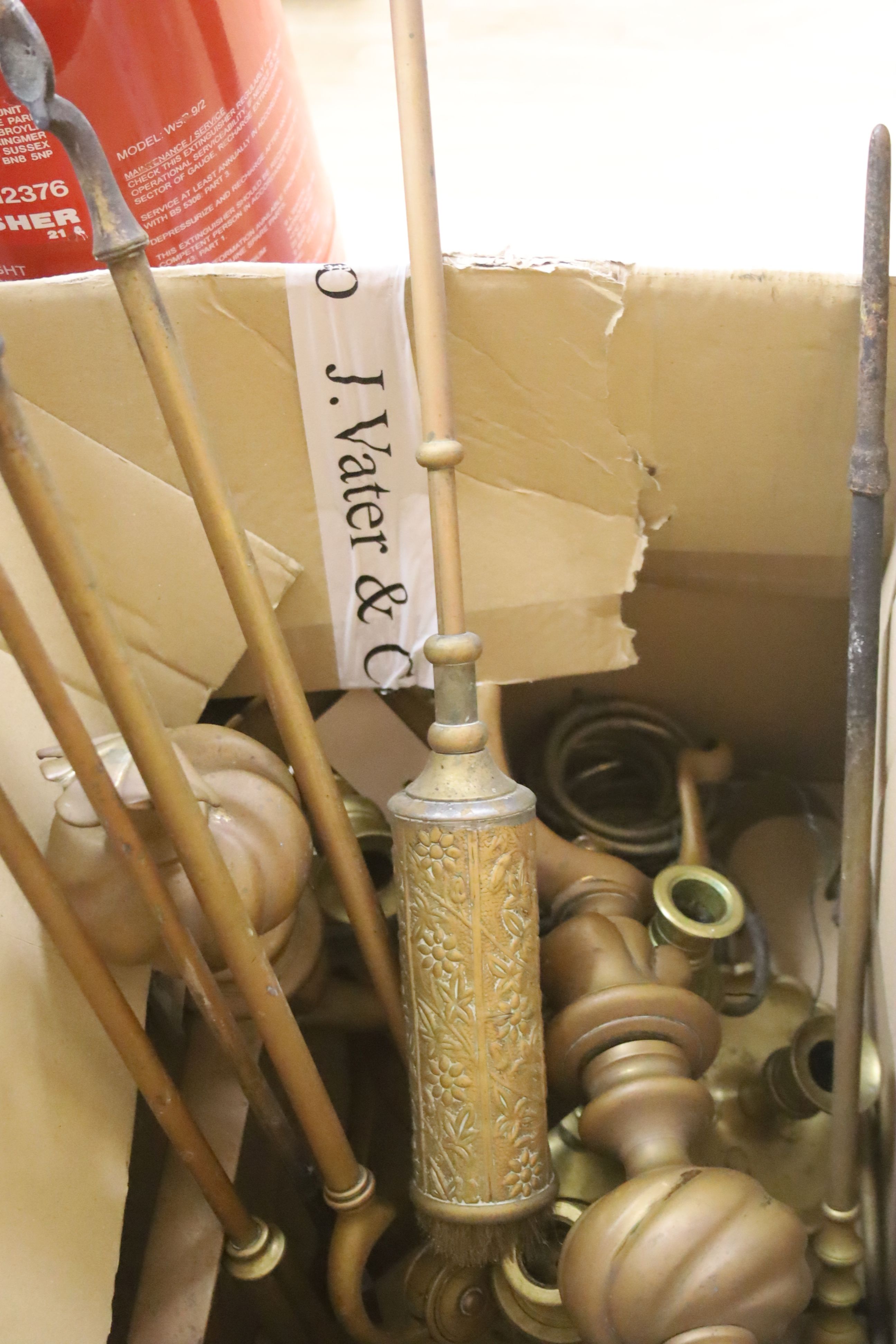 Sundry metalware, including a pair of fire dogs, various fire implements, brass chambersticks and candlesticks and an antique long brass curtain rail